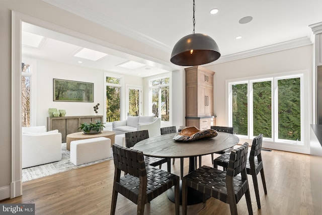 dining area featuring recessed lighting, a skylight, crown molding, and light wood-style floors