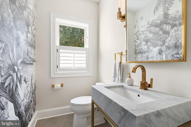 bathroom featuring tile patterned floors, toilet, vanity, and baseboards