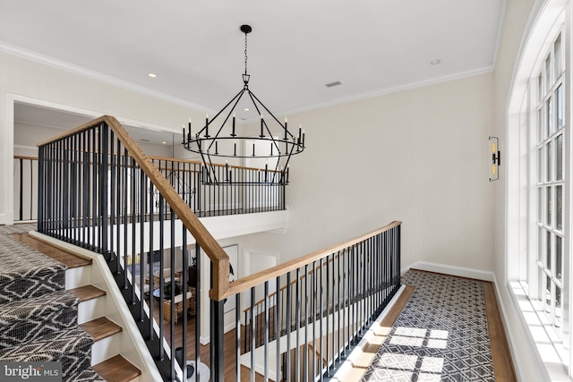 stairs featuring recessed lighting, a chandelier, baseboards, and ornamental molding