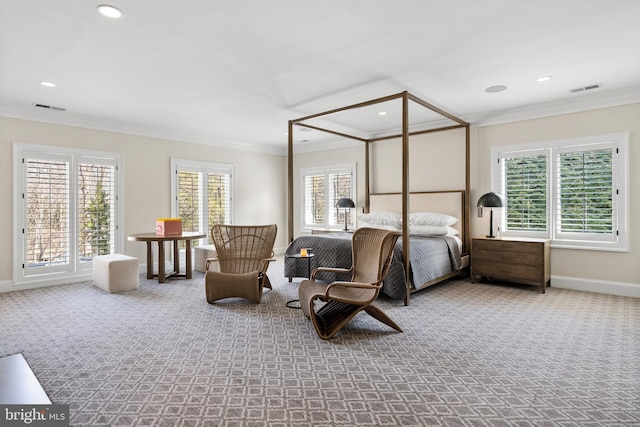 carpeted bedroom featuring visible vents, multiple windows, baseboards, and ornamental molding