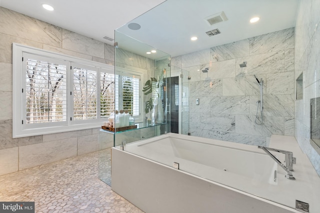 full bath with visible vents, a tub, recessed lighting, tiled shower, and tile walls