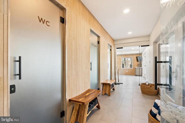 hallway featuring recessed lighting and light tile patterned flooring