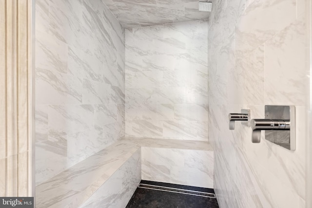 interior details with a tile shower