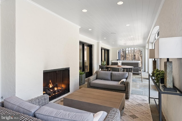 living area featuring crown molding, recessed lighting, wooden ceiling, and a lit fireplace