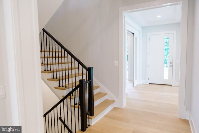 foyer entrance with recessed lighting, light wood-style flooring, baseboards, and stairs