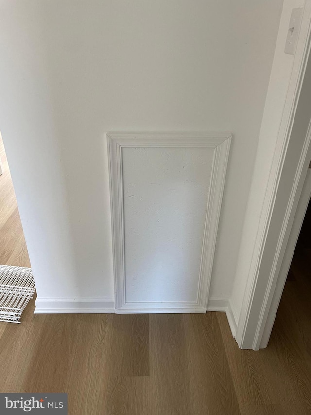 interior details with baseboards and wood finished floors