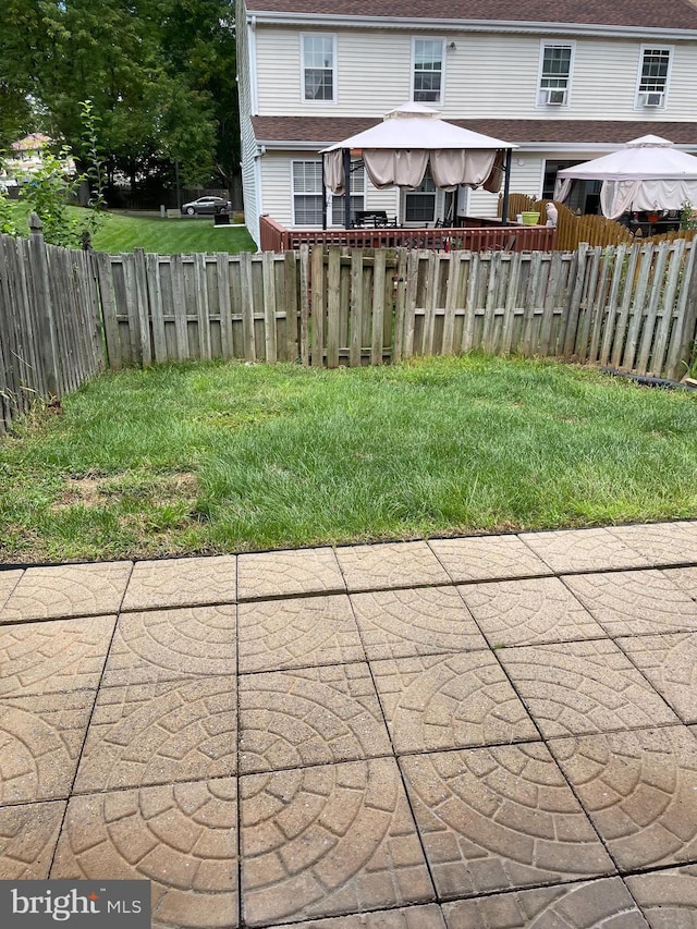 view of yard with a patio area, a fenced backyard, and a gazebo