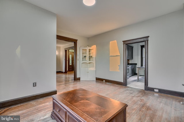 living area featuring light wood-type flooring and baseboards