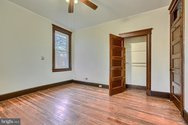 unfurnished bedroom featuring ornamental molding and wood finished floors