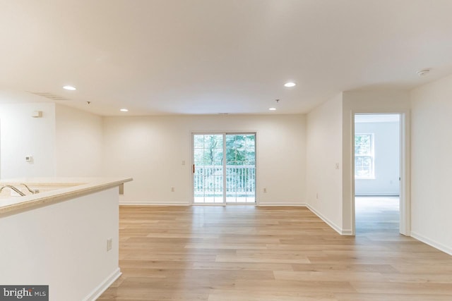 spare room featuring baseboards, light wood-style flooring, and recessed lighting