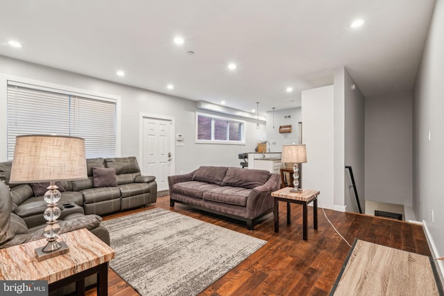 living room featuring recessed lighting, visible vents, and dark wood finished floors