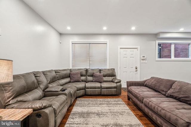 living room with dark wood-style floors and recessed lighting