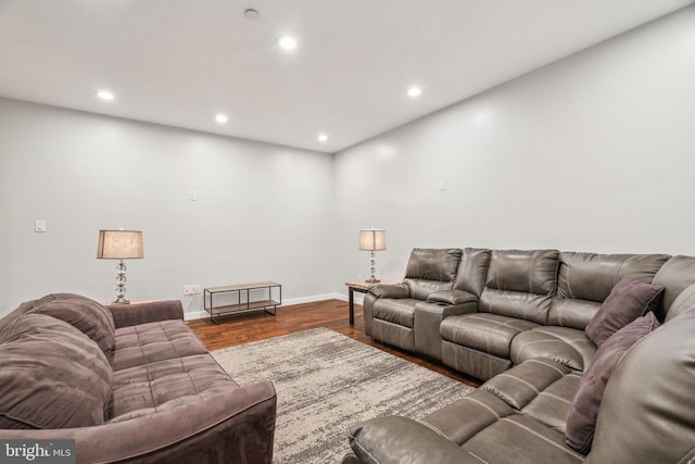 living room with baseboards, wood finished floors, and recessed lighting