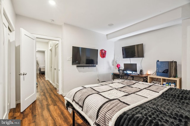 bedroom featuring baseboards and wood finished floors