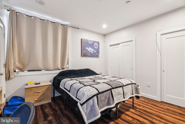 bedroom with dark wood-style floors and recessed lighting