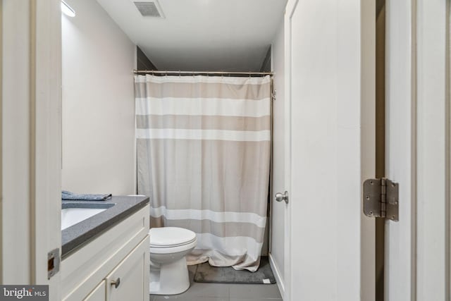 bathroom with curtained shower, visible vents, toilet, vanity, and tile patterned floors