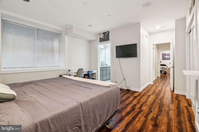 bedroom featuring dark wood finished floors and baseboards