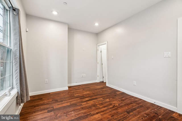 unfurnished room featuring recessed lighting, baseboards, and wood finished floors