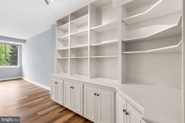 room details featuring baseboards and wood finished floors