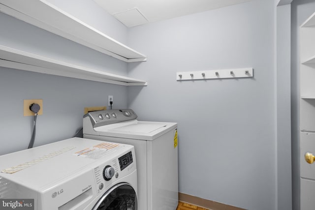 clothes washing area with laundry area and washer and clothes dryer