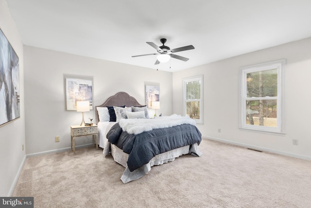 bedroom with light colored carpet, visible vents, and baseboards