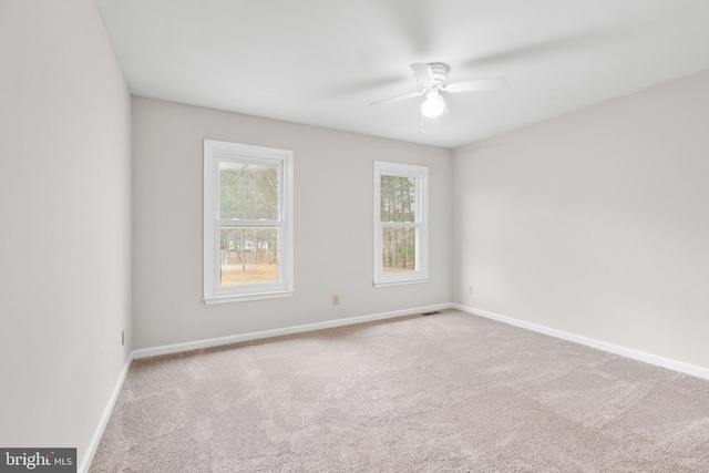 unfurnished room featuring carpet flooring, a ceiling fan, and baseboards