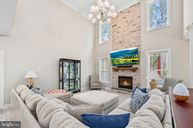 living room featuring a stone fireplace, baseboards, a healthy amount of sunlight, and ornamental molding