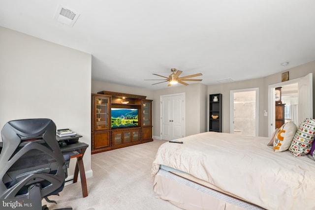 bedroom featuring baseboards, visible vents, ceiling fan, light colored carpet, and connected bathroom