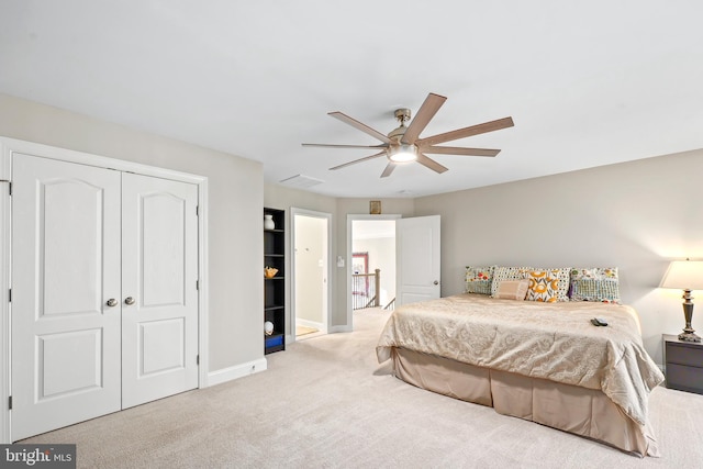 carpeted bedroom featuring a closet, visible vents, ceiling fan, and baseboards