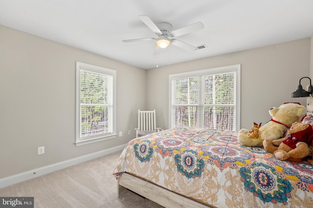 bedroom featuring multiple windows, carpet, visible vents, and baseboards