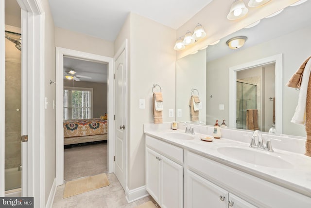 ensuite bathroom with a sink, a shower with door, connected bathroom, tile patterned flooring, and double vanity