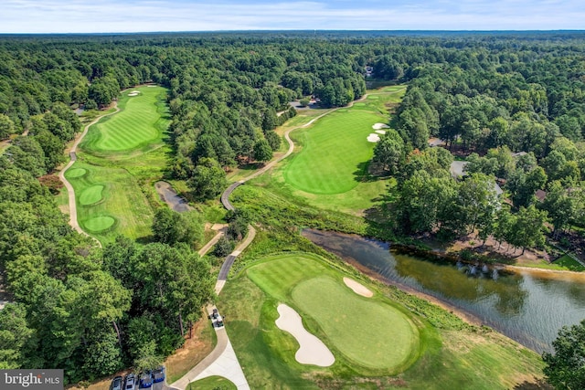 birds eye view of property featuring golf course view, a view of trees, and a water view