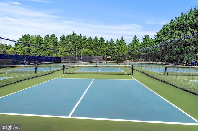 view of sport court featuring fence