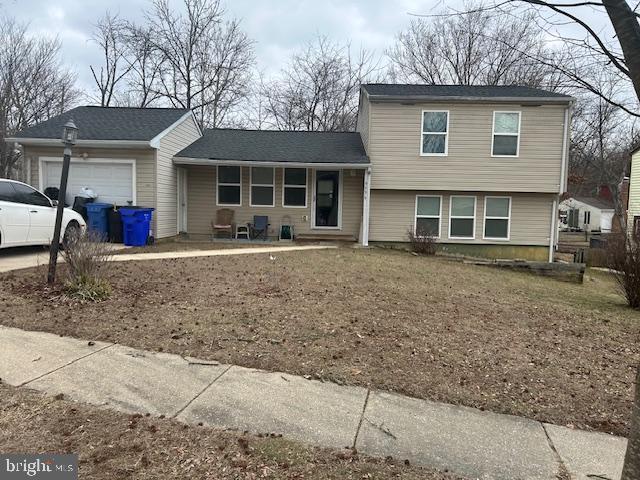 tri-level home featuring a garage and driveway