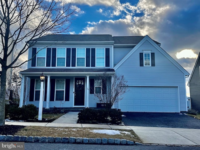 traditional-style home with driveway and an attached garage