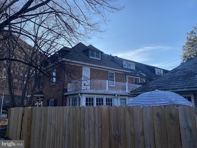 back of house with fence and brick siding