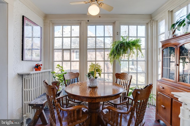 sunroom featuring ceiling fan and a wealth of natural light