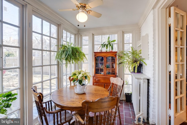 sunroom featuring radiator heating unit and ceiling fan