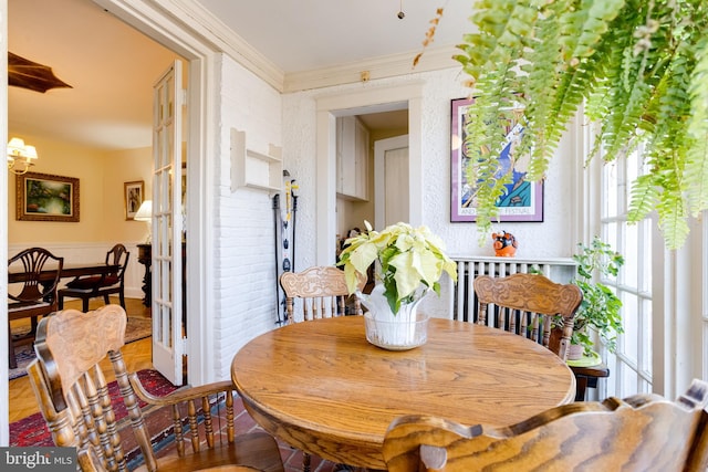 dining space with a notable chandelier, a healthy amount of sunlight, and crown molding