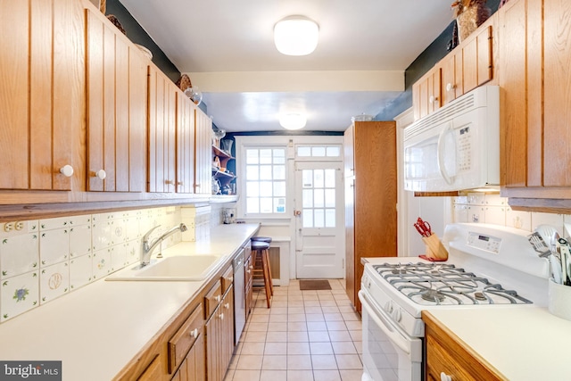 kitchen with white appliances, light tile patterned floors, light countertops, open shelves, and a sink