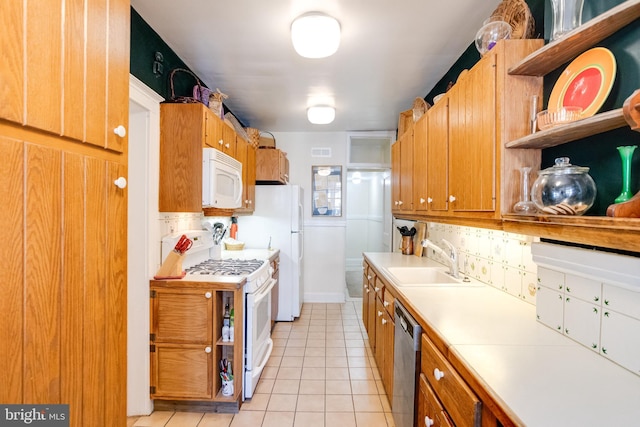 kitchen with white appliances, decorative backsplash, light countertops, open shelves, and a sink