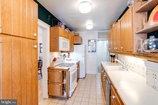 kitchen with white appliances, light countertops, a sink, and open shelves