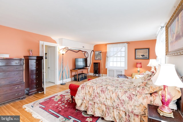 bedroom with baseboards and wood finished floors