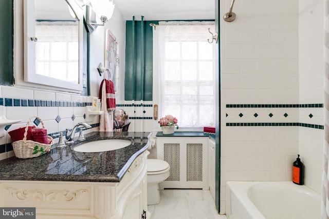 full bathroom featuring radiator, a healthy amount of sunlight, tile walls, and vanity