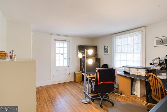 home office featuring light wood-style flooring and baseboards