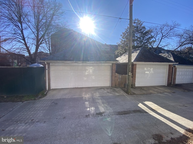 detached garage featuring fence