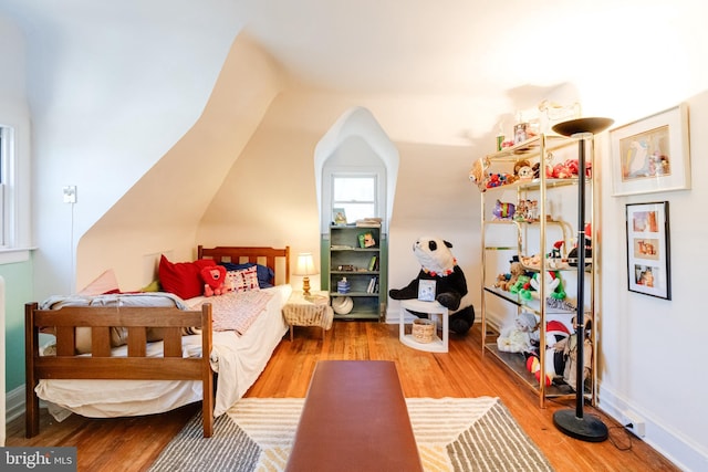 bedroom featuring wood finished floors and baseboards