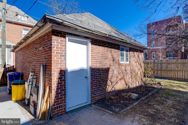 view of outbuilding featuring fence