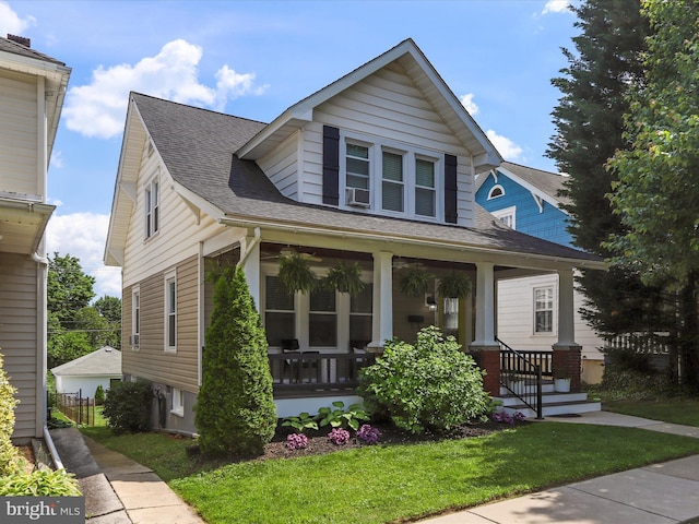 bungalow featuring a porch and a shingled roof