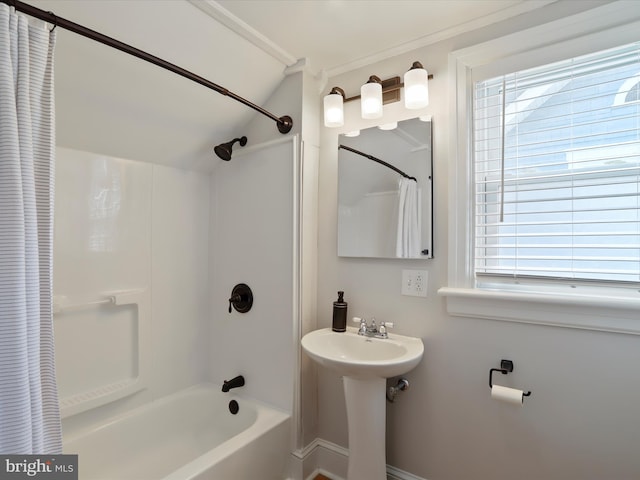 bathroom with a wealth of natural light, a sink, and shower / bathtub combination with curtain